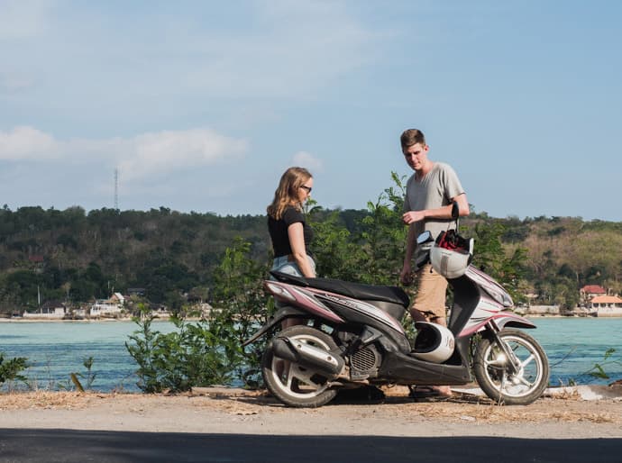 Path leading down to Gamat Bay beach through tropical vegetation